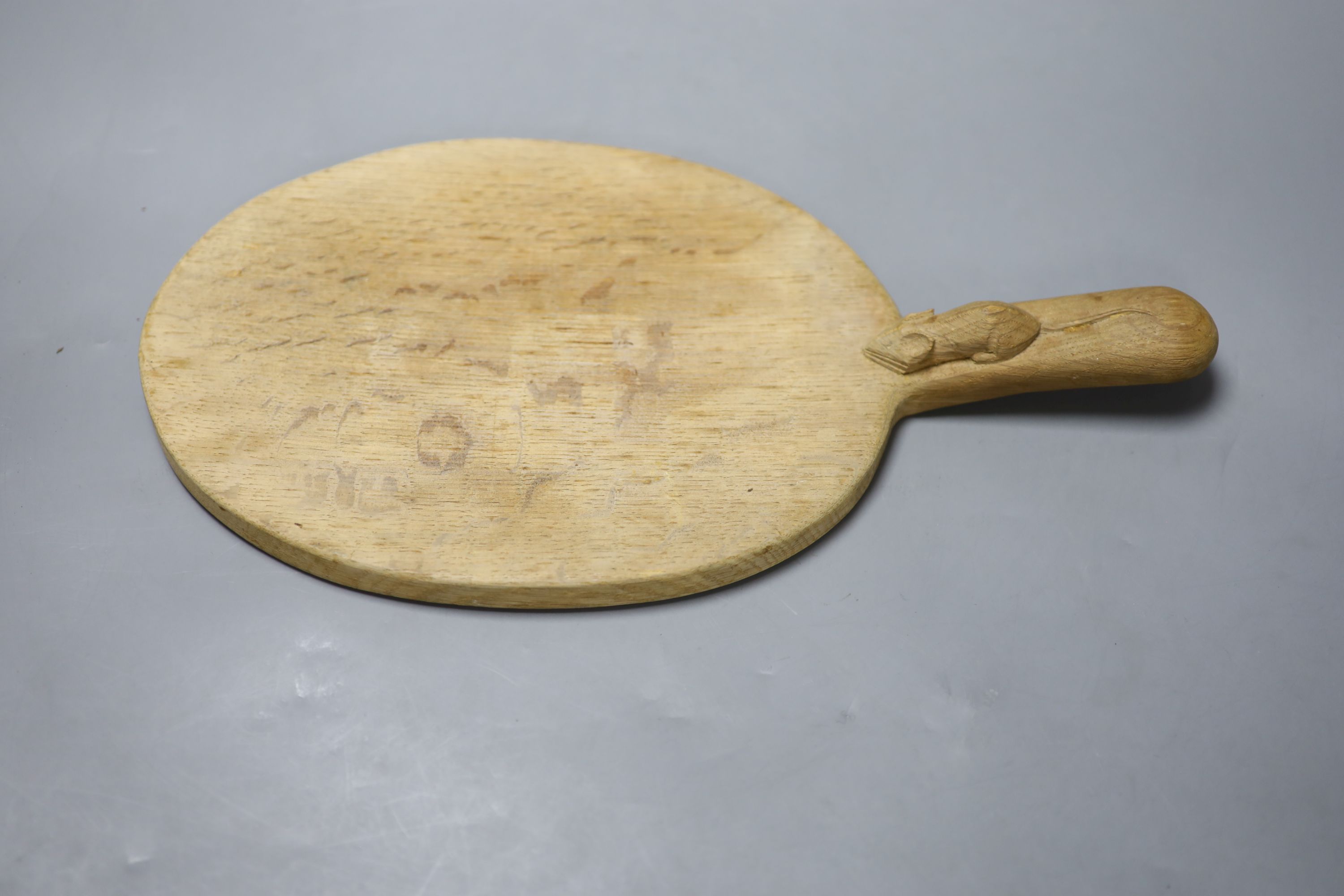 A Robert Thompson, The Mouseman, an oval oak cheese board, length 38cm